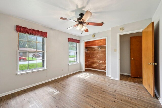 5960 Navajo Trl, Beaumont, TX 77708 - unfurnished bedroom with baseboards, wood finished floors, a closet, and a ceiling fan
