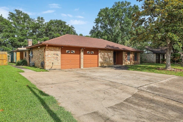 5960 Navajo Trl, Beaumont, TX 77708 - view of front facade with brick siding, an attached garage, a chimney, a front yard, and driveway
