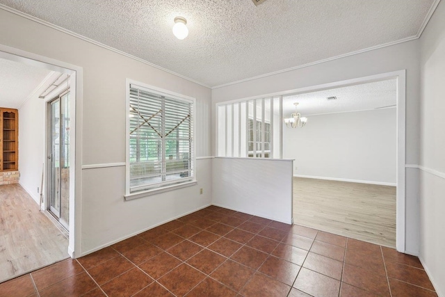 5960 Navajo Trl, Beaumont, TX 77708 - unfurnished room featuring crown molding, a chandelier, dark tile patterned flooring, and a textured ceiling