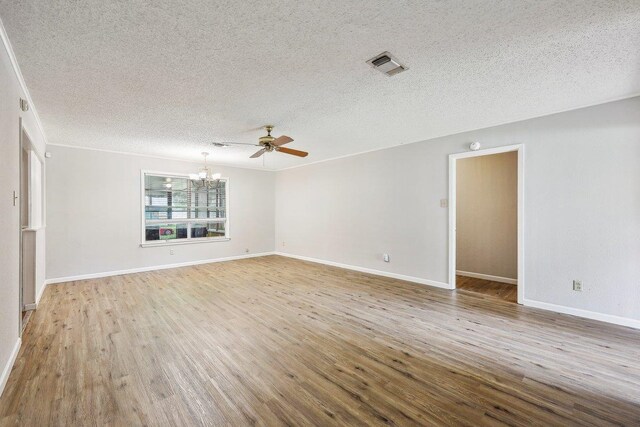 5960 Navajo Trl, Beaumont, TX 77708 - unfurnished room with a chandelier, a textured ceiling, wood finished floors, baseboards, and ceiling fan