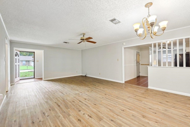 5960 Navajo Trl, Beaumont, TX 77708 - unfurnished living room featuring a textured ceiling, wood finished floors, a chandelier, a ceiling fan, and baseboards