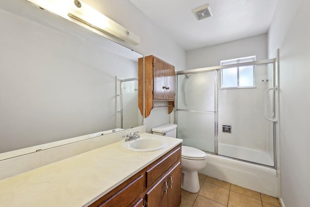 5960 Navajo Trl, Beaumont, TX 77708 - bathroom with toilet, vanity, tile patterned floors, and combined bath / shower with glass door