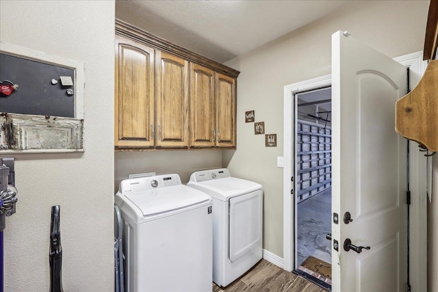 3113 Labrador Ln, Port Neches, TX 77651 - clothes washing area featuring washing machine and clothes dryer, baseboards, wood finished floors, and cabinet space