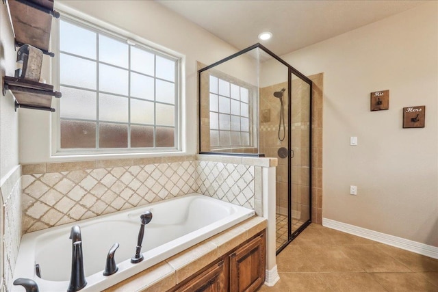3113 Labrador Ln, Port Neches, TX 77651 - bathroom with baseboards, tile patterned floors, a bath, and a stall shower