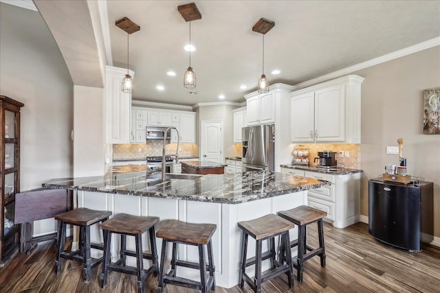 3113 Labrador Ln, Port Neches, TX 77651 - kitchen featuring backsplash, stainless steel appliances, white cabinets, and dark wood-type flooring