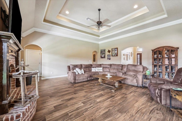 3113 Labrador Ln, Port Neches, TX 77651 - living area with ceiling fan, arched walkways, wood finished floors, baseboards, and a tray ceiling