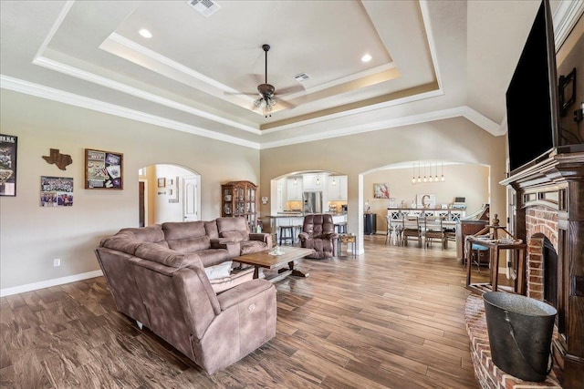 3113 Labrador Ln, Port Neches, TX 77651 - living room with visible vents, arched walkways, a raised ceiling, and a ceiling fan