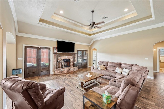 3113 Labrador Ln, Port Neches, TX 77651 - living room featuring visible vents, a ceiling fan, baseboards, a raised ceiling, and arched walkways