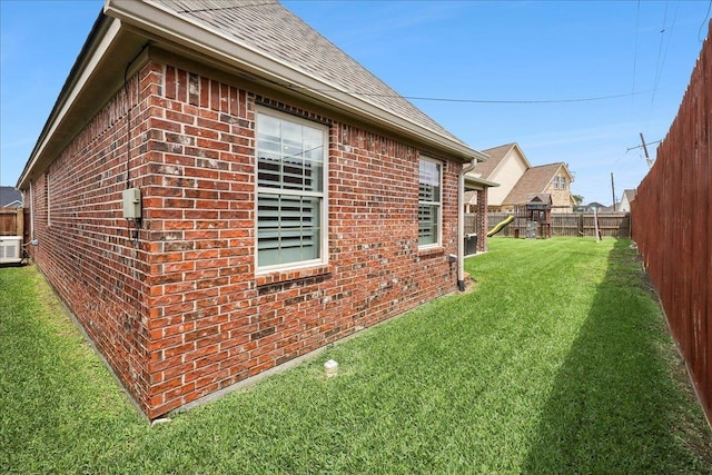 3113 Labrador Ln, Port Neches, TX 77651 - view of property exterior featuring a fenced backyard, a shingled roof, a yard, and brick siding