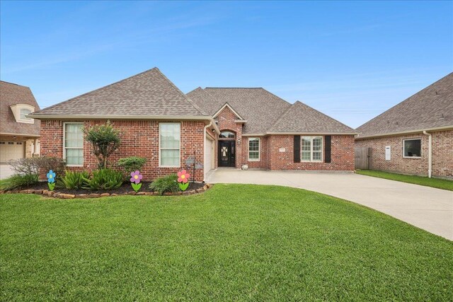 3113 Labrador Ln, Port Neches, TX 77651 - ranch-style home with an attached garage, a shingled roof, a front lawn, brick siding, and concrete driveway