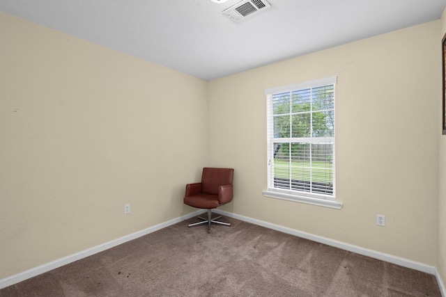 unfurnished room with visible vents, carpet flooring, and baseboards