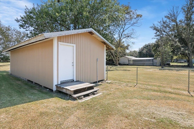 view of outdoor structure featuring a lawn