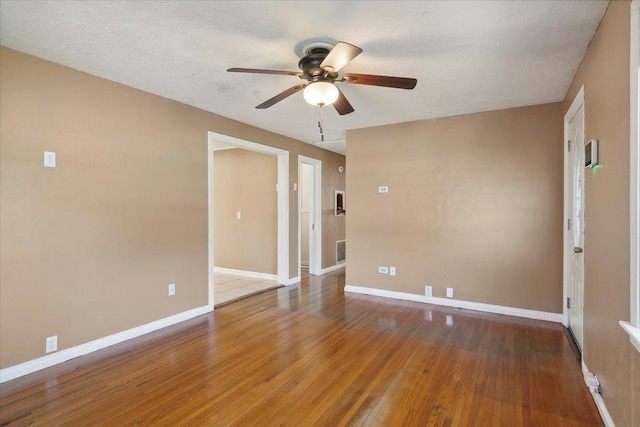 empty room with wood-type flooring, a textured ceiling, and ceiling fan