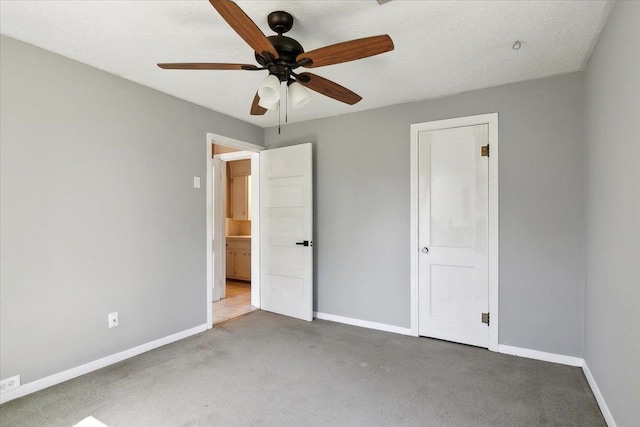 unfurnished bedroom featuring a textured ceiling, ceiling fan, and light carpet