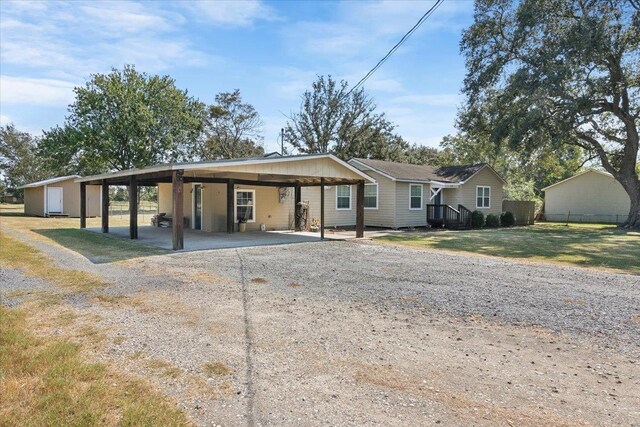 view of front facade with a carport and a front lawn