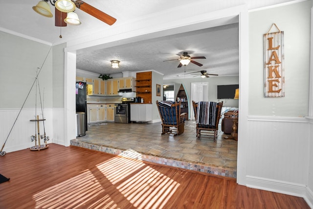 living room featuring wood-type flooring, a textured ceiling, and crown molding