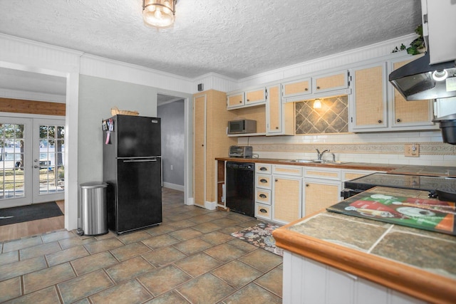 kitchen with french doors, sink, a textured ceiling, black appliances, and ornamental molding