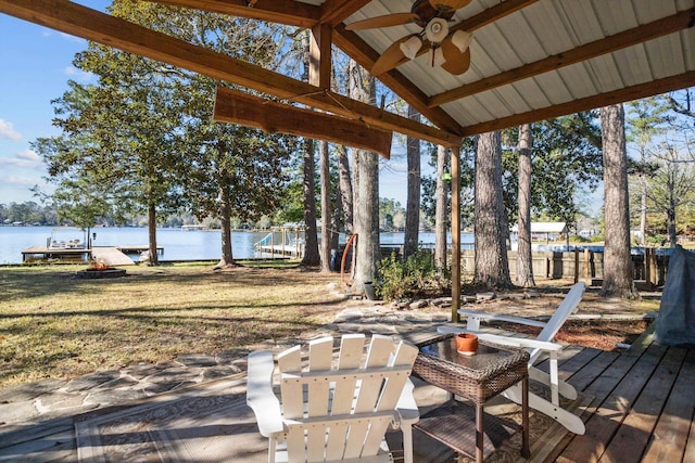 wooden terrace featuring a water view and ceiling fan