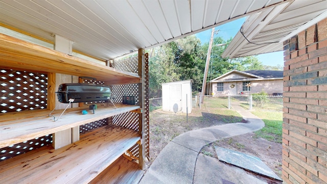 1005 Black Walnut Ln, Jasper, TX 75951 - view of patio with fence, a storage unit, a wooden deck, and an outdoor structure