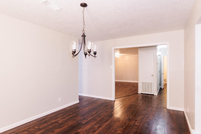 unfurnished dining area with dark wood-type flooring and a chandelier