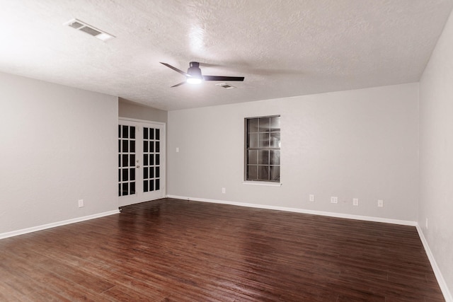 spare room with french doors, ceiling fan, dark hardwood / wood-style flooring, and a textured ceiling