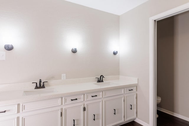 bathroom featuring hardwood / wood-style flooring, vanity, and toilet