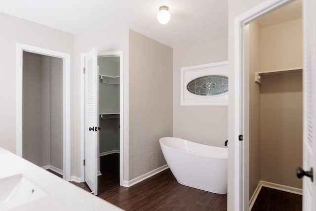 bathroom featuring vanity, a bathtub, and hardwood / wood-style flooring