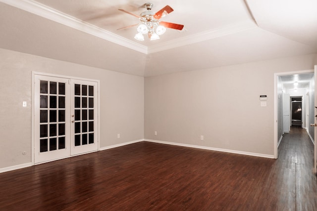 spare room with dark hardwood / wood-style floors, ornamental molding, a raised ceiling, and french doors