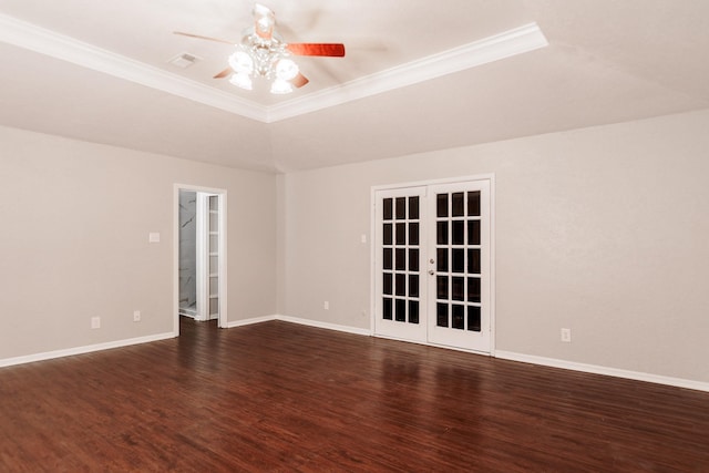 spare room with ornamental molding, a tray ceiling, and french doors