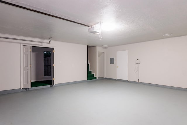 garage featuring a garage door opener and electric panel