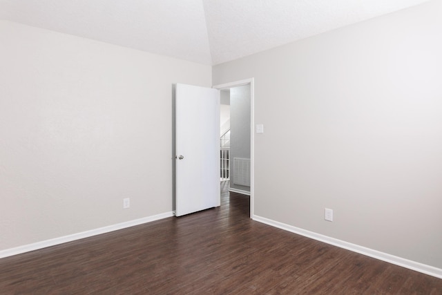 empty room with dark hardwood / wood-style floors