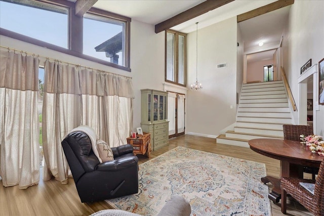 5955 Bicentennial Ln, Beaumont, TX 77706 - living area featuring plenty of natural light, wood finished floors, stairway, a high ceiling, and beam ceiling