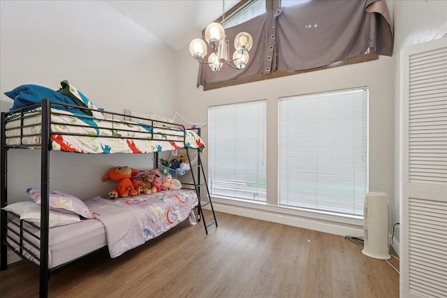 5955 Bicentennial Ln, Beaumont, TX 77706 - bedroom featuring wood finished floors, a chandelier, a closet, and vaulted ceiling