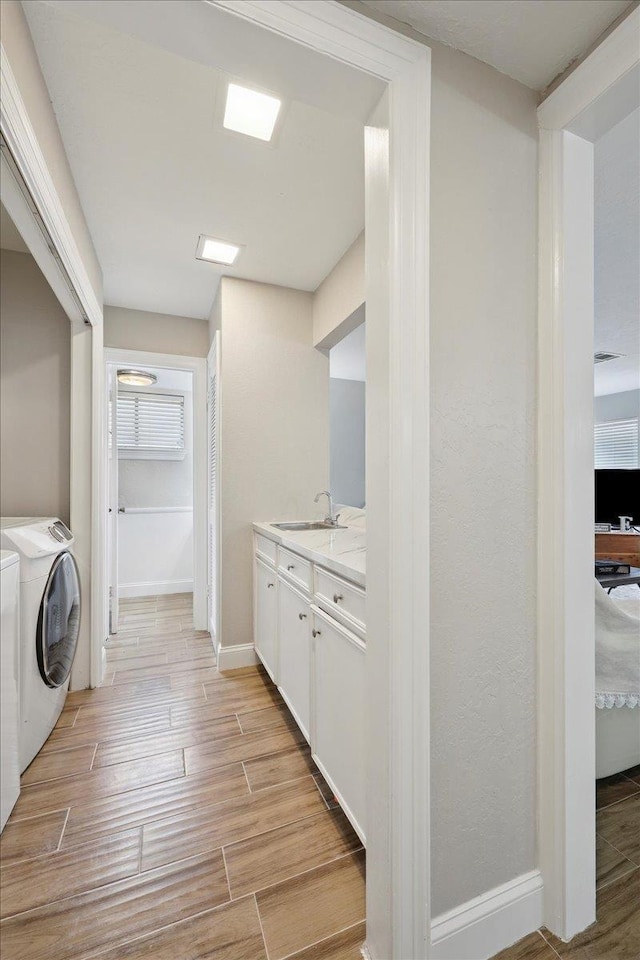 5955 Bicentennial Ln, Beaumont, TX 77706 - laundry room with light wood finished floors and baseboards