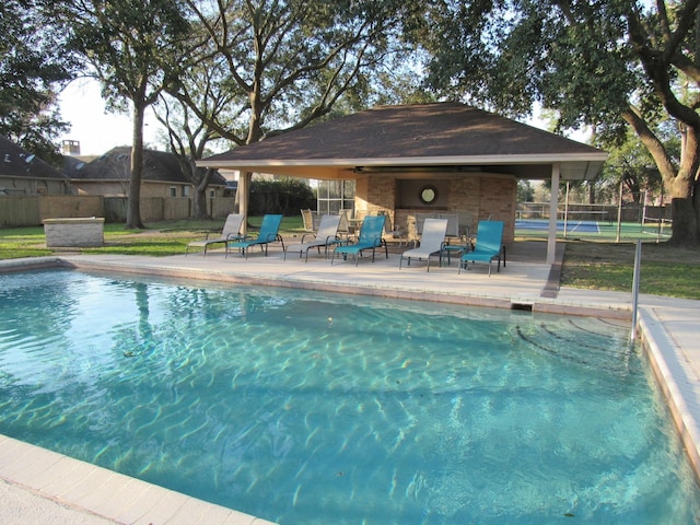 view of swimming pool with a patio area, fence, and a fenced in pool