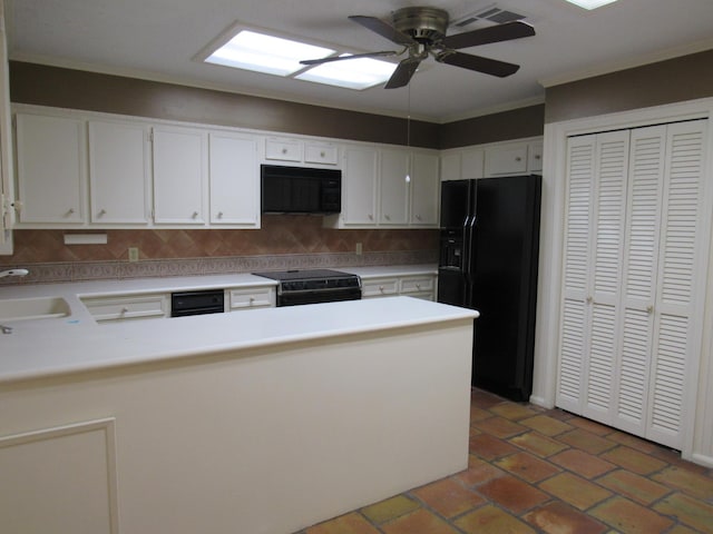 kitchen with black appliances, a peninsula, a sink, and light countertops