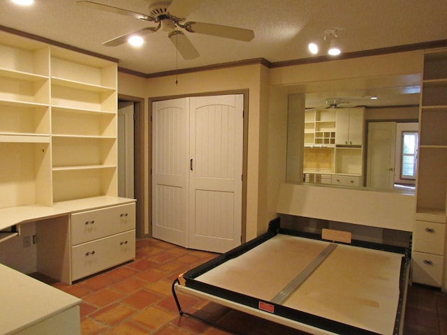 bedroom with ornamental molding, a closet, brick floor, and a ceiling fan