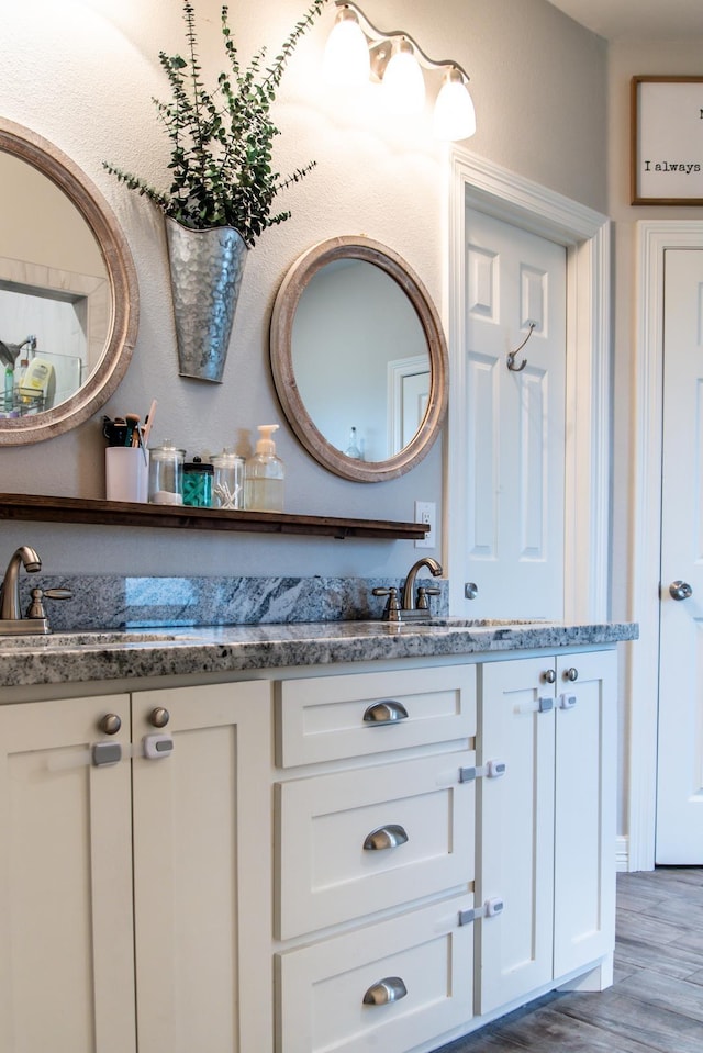 bathroom featuring vanity and hardwood / wood-style flooring