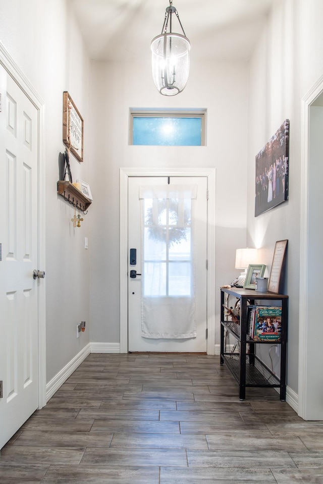 entrance foyer with a notable chandelier and hardwood / wood-style floors