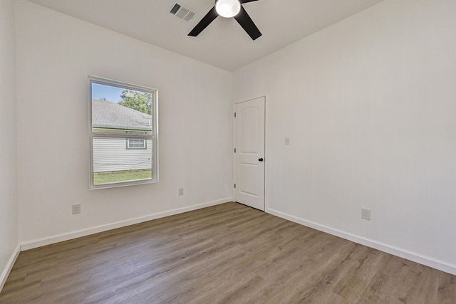 empty room with hardwood / wood-style floors and ceiling fan