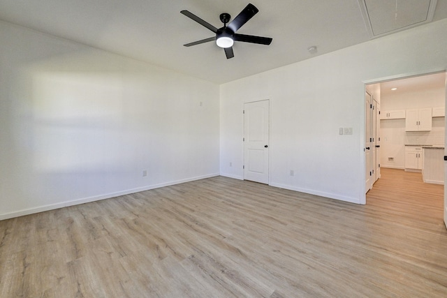 spare room with light hardwood / wood-style floors and ceiling fan