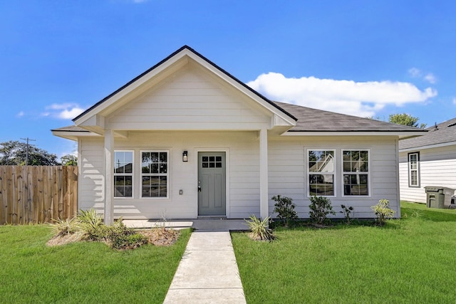 bungalow-style house featuring covered porch and a front lawn