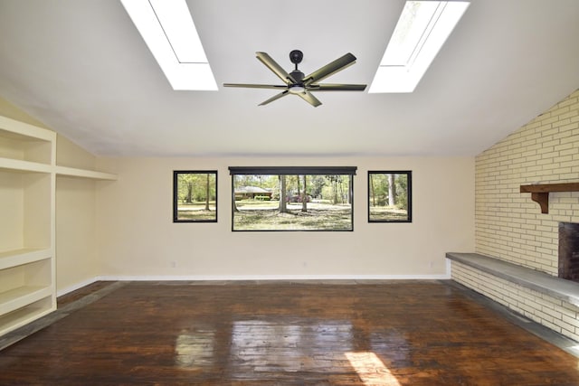 unfurnished living room featuring a wealth of natural light, vaulted ceiling with skylight, ceiling fan, and hardwood / wood-style flooring