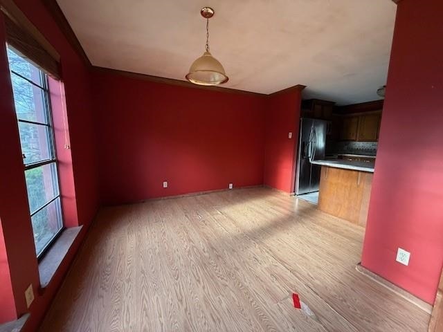 unfurnished dining area with light wood-style flooring