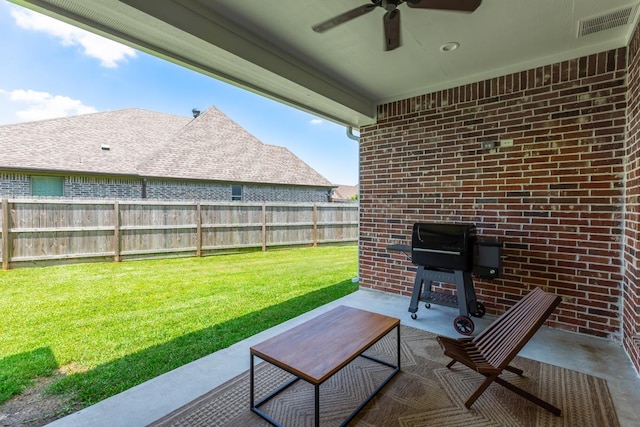 4813 Augusta Dr, Groves, TX 77619 - fenced backyard with a ceiling fan, a patio area, and a grill