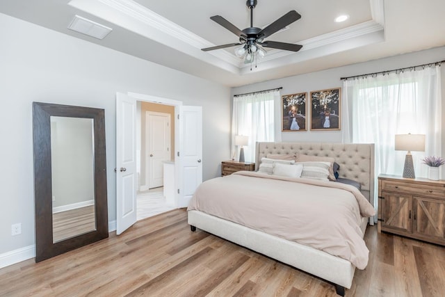 4813 Augusta Dr, Groves, TX 77619 - bedroom featuring a tray ceiling, crown molding, light wood-style flooring, recessed lighting, and a ceiling fan