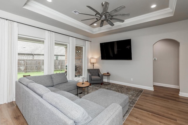 4813 Augusta Dr, Groves, TX 77619 - living room with a tray ceiling, arched walkways, a ceiling fan, wood finished floors, and crown molding