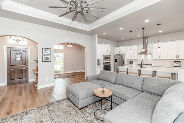 4813 Augusta Dr, Groves, TX 77619 - living room with ceiling fan, arched walkways, recessed lighting, ornamental molding, and light wood-style floors