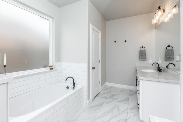 4813 Augusta Dr, Groves, TX 77619 - bathroom featuring vanity, a bath, and marble look tiles