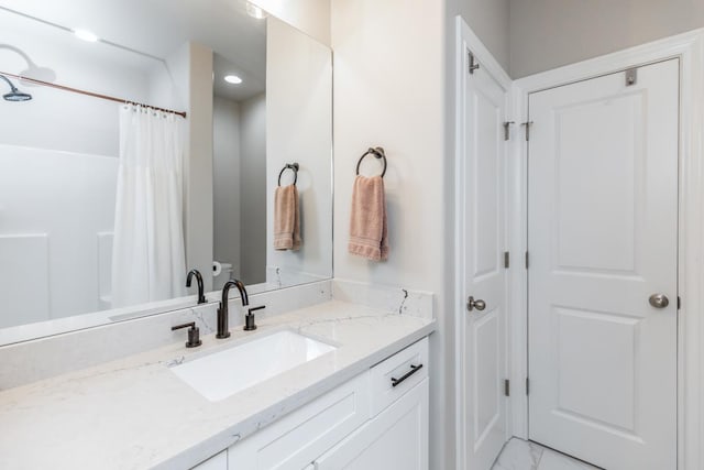 4813 Augusta Dr, Groves, TX 77619 - bathroom featuring vanity, marble finish floors, and curtained shower